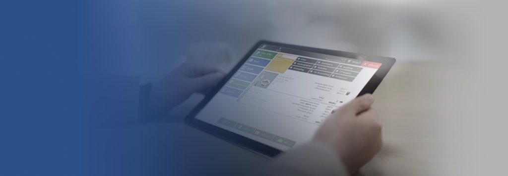 Hände halten ein Tablet mit der touchoptimierten Verkaufs- und Kassenoberfläche von crystalworks.